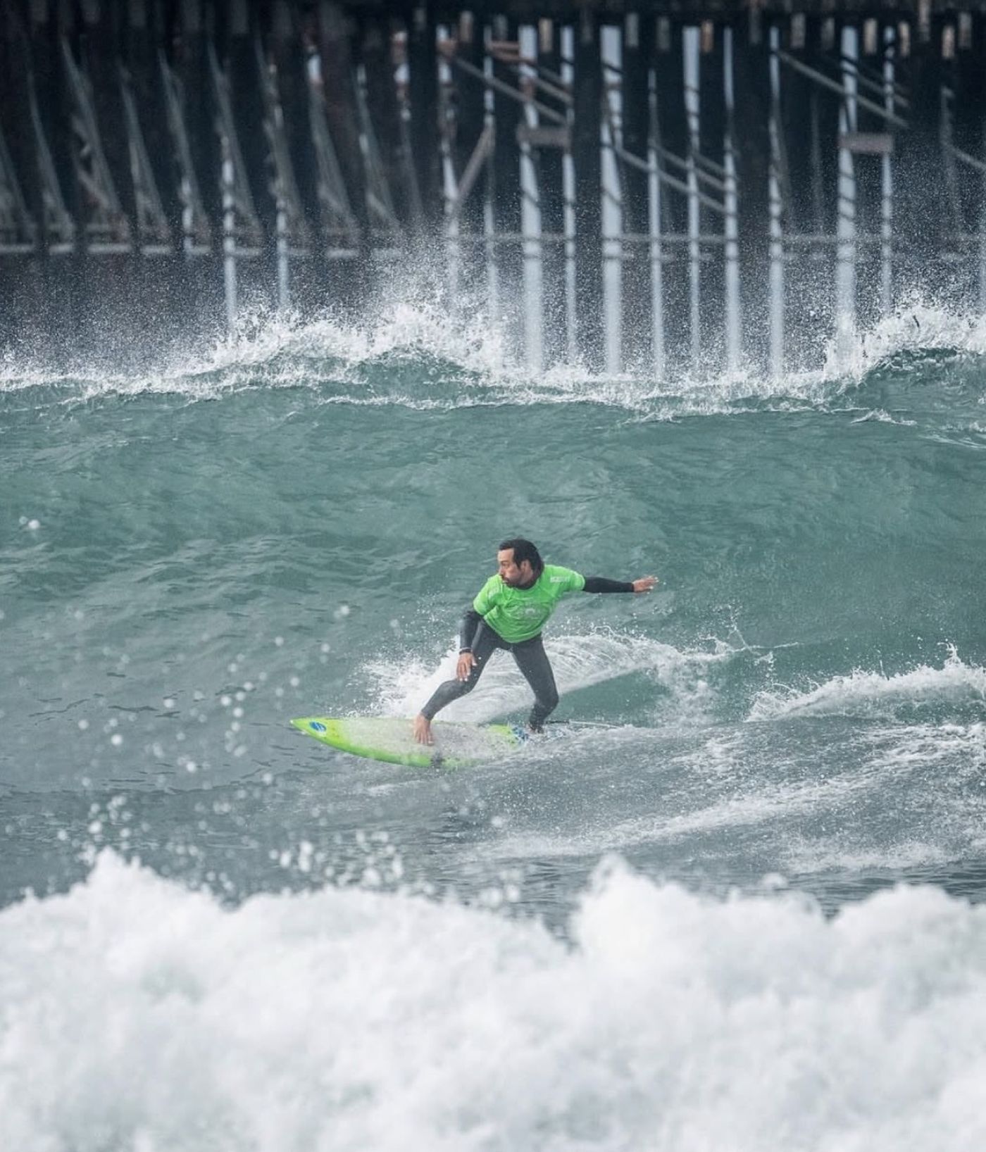 An adaptive surfer carving a wave