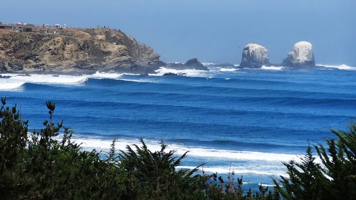 Waves wrapping around the rock stacks at Punta de Lobos, Chile
